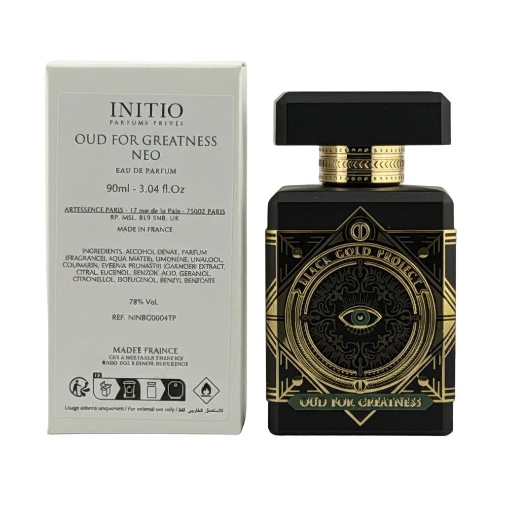 Perfume bottle with gold accents and packaging on a white background