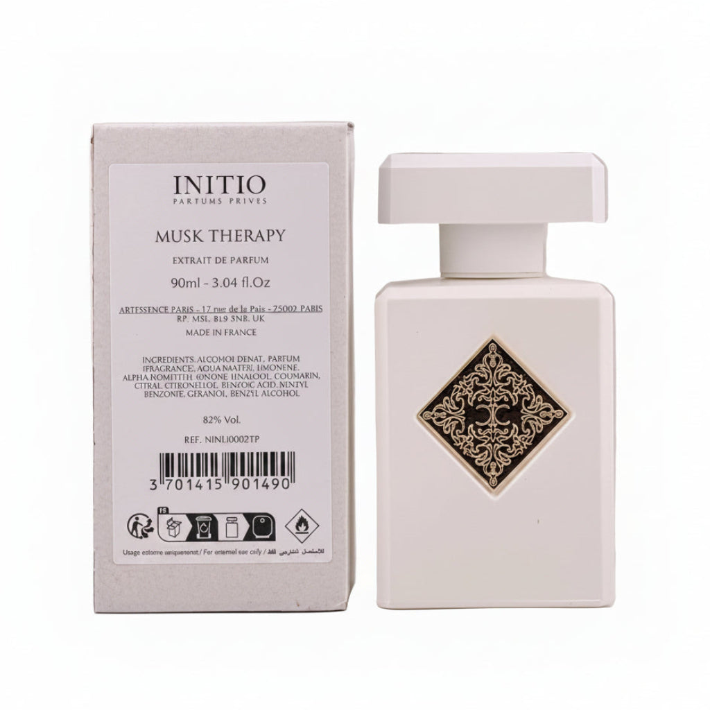 White perfume bottle with decorative label next to its packaging on a light gray background