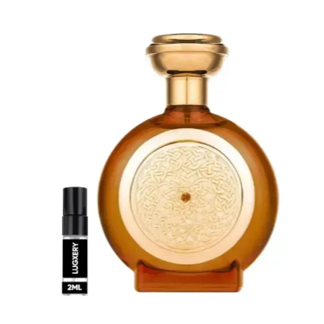 Tobacco Sapphire Boadicea. Amber perfume bottle with gold cap and smaller black and white rollerball on a white background