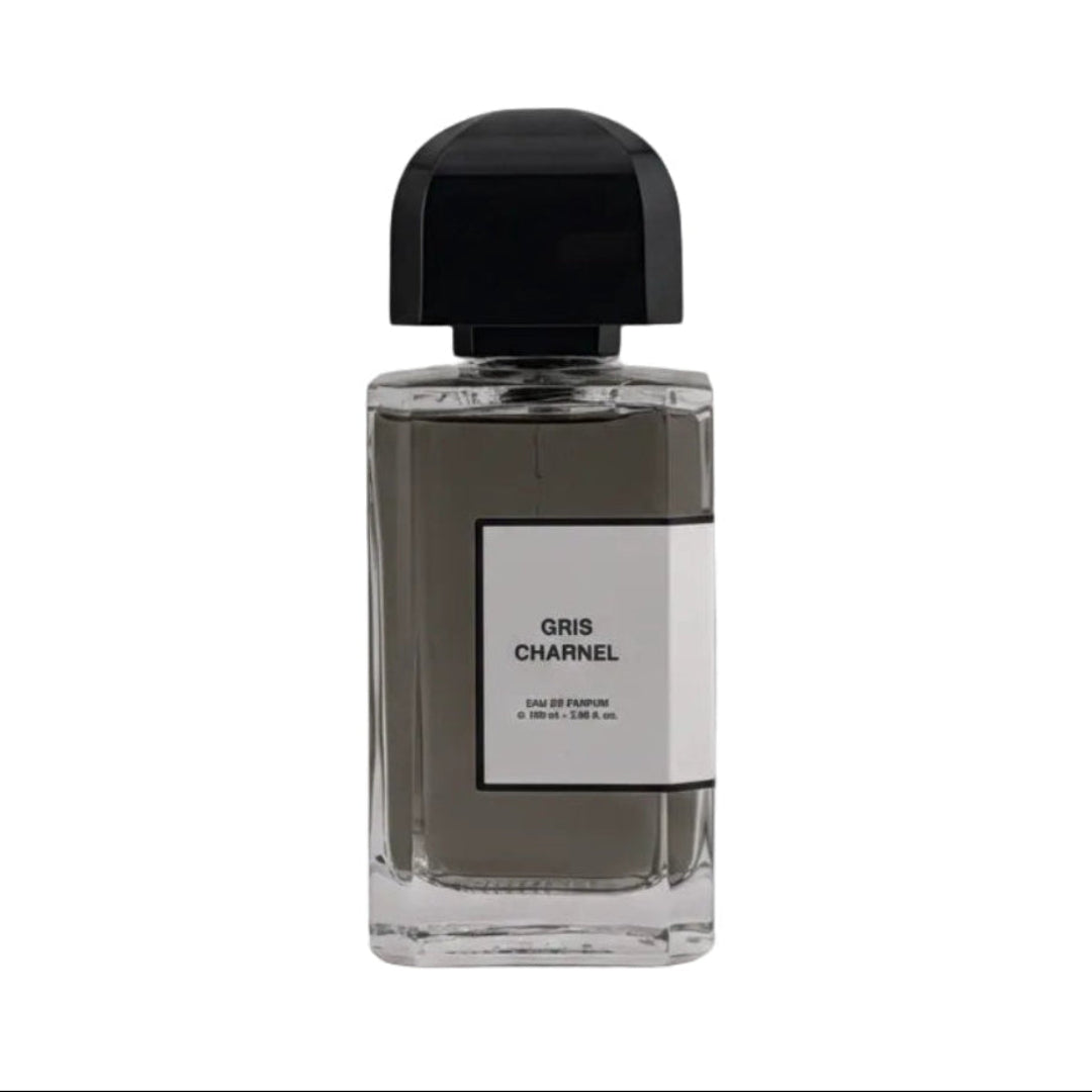 A bottle of Chanel Gris Charnel Eau de Parfum with a black cap and a white label, set against a neutral gray background.