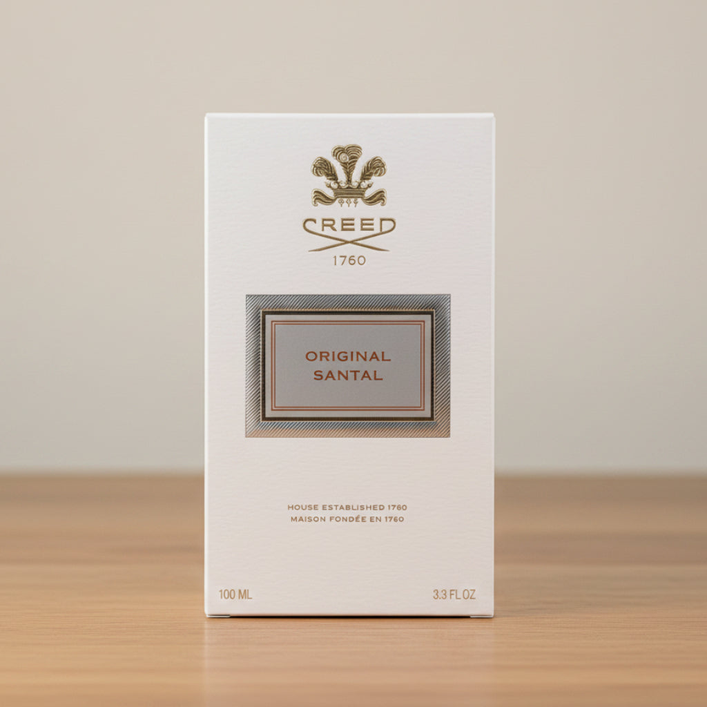 Creed Original Santal perfume packaging on a gray background