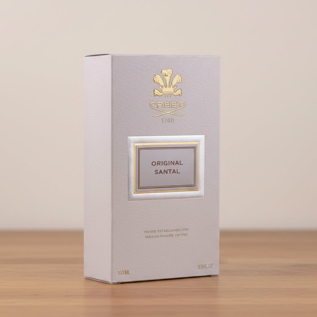 Perfume box labeled 'Original Santal' by Creed on a gray background