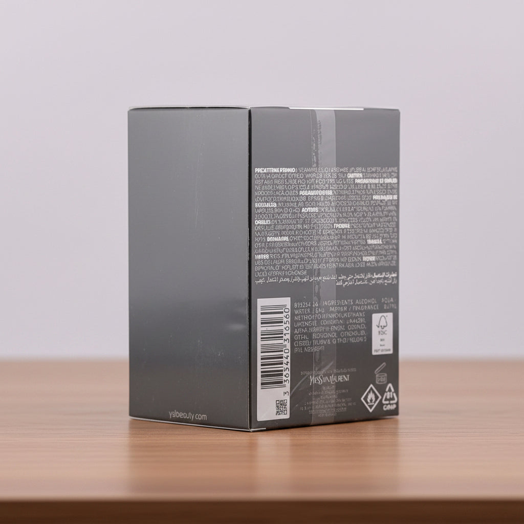 The back of a dark gray rectangular product box, sealed in plastic wrap, showing printed text, a barcode, and recycling symbols on a light gray background.