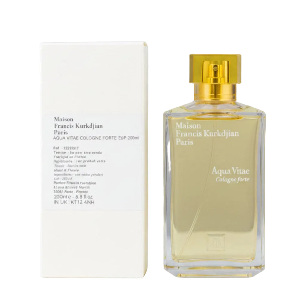 A bottle of Maison Francis Kurkdjian Aqua Vita Eau de Parfum with a translucent yellow cap and golden liquid, standing next to its white textured packaging box on a dark reflective surface.
