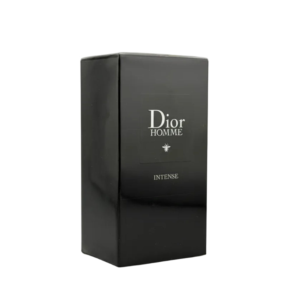A black Dior Homme Intense perfume box with white lettering, photographed from a top-down angle on a light gray background.