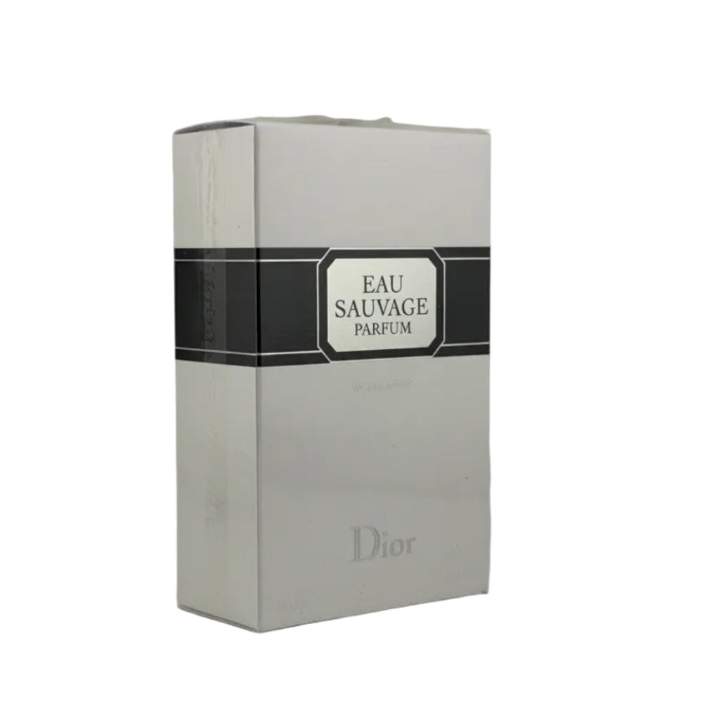 Dior Eau Sauvage Parfum box in white with a black central label band, photographed on a light gray surface.