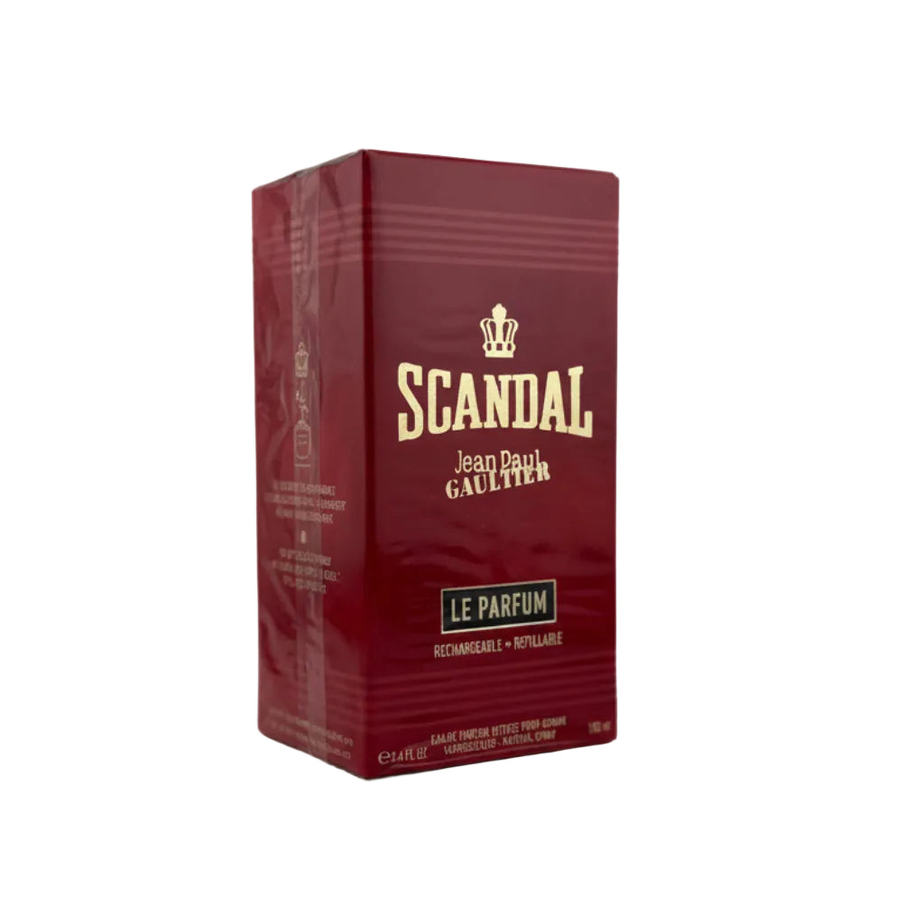 A red rectangular box of Scandal Le Parfum by Jean Paul Gaultier, wrapped in protective plastic, set against a neutral gray background.