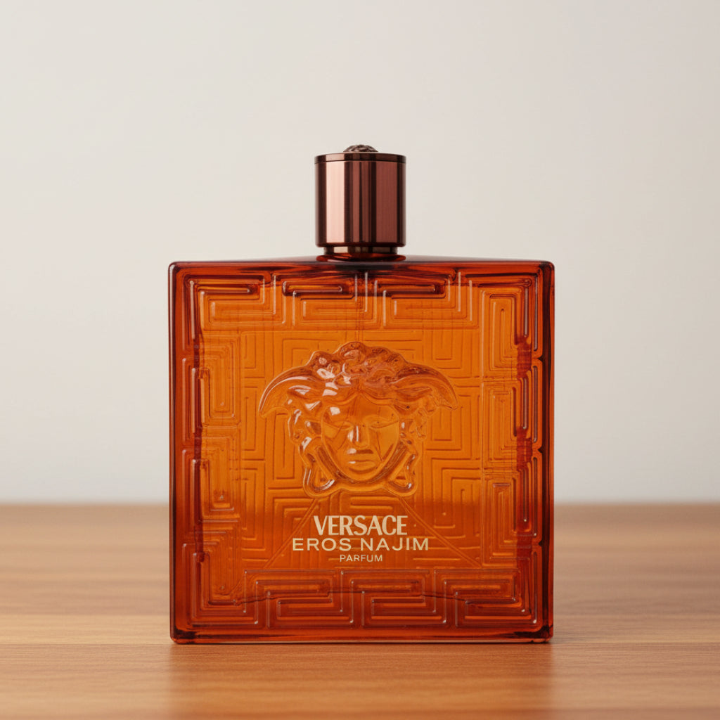Versace Eros-Najim Parfum bottle, featuring a translucent amber-brown glass design with an embossed Medusa head and geometric maze pattern, topped with a metallic bronze cap.