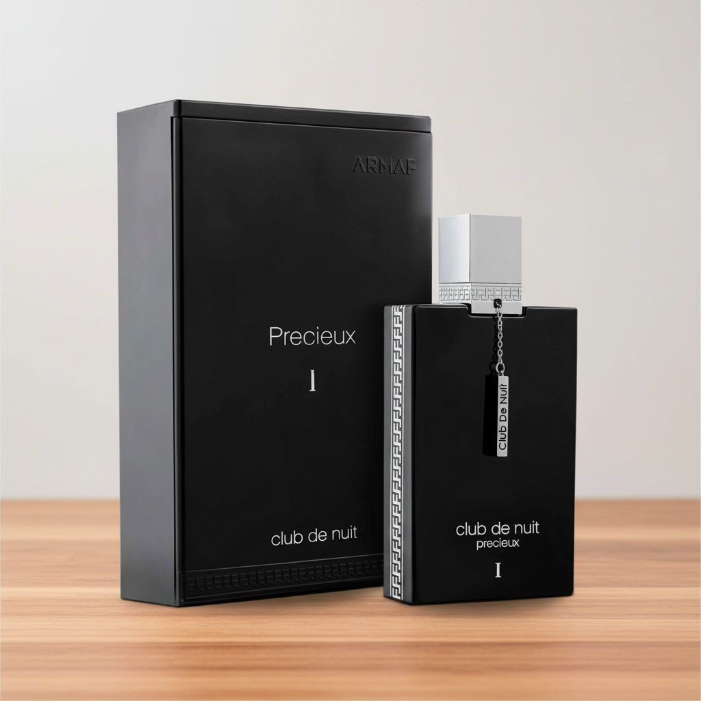 Black perfume bottle and packaging with 'club de nuit' branding on a white background