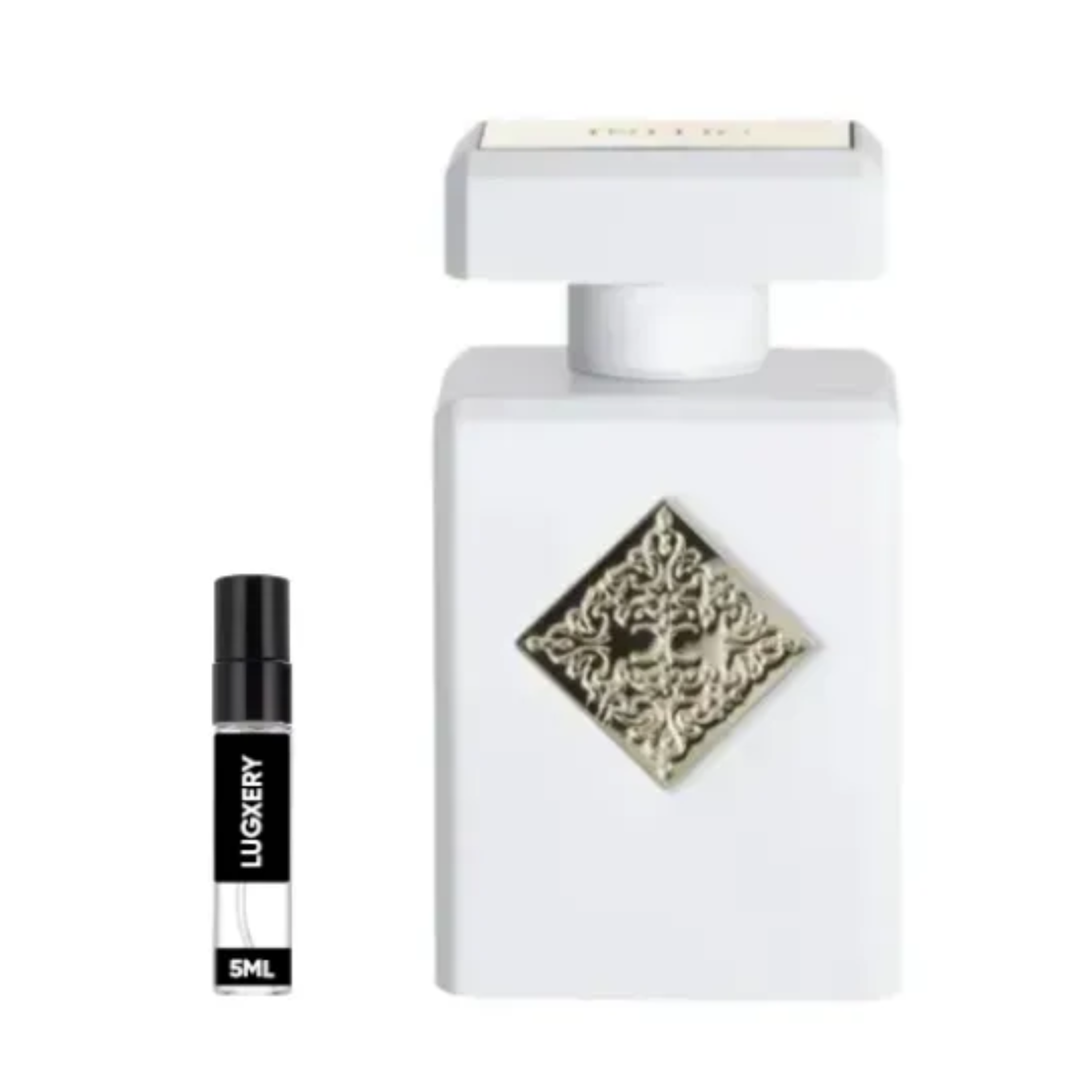 White perfume bottle with decorative cap and smaller black bottle labeled 'LUXERY' on a white background