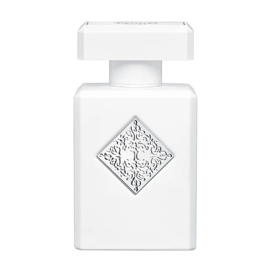 White perfume bottle with decorative label on a white background