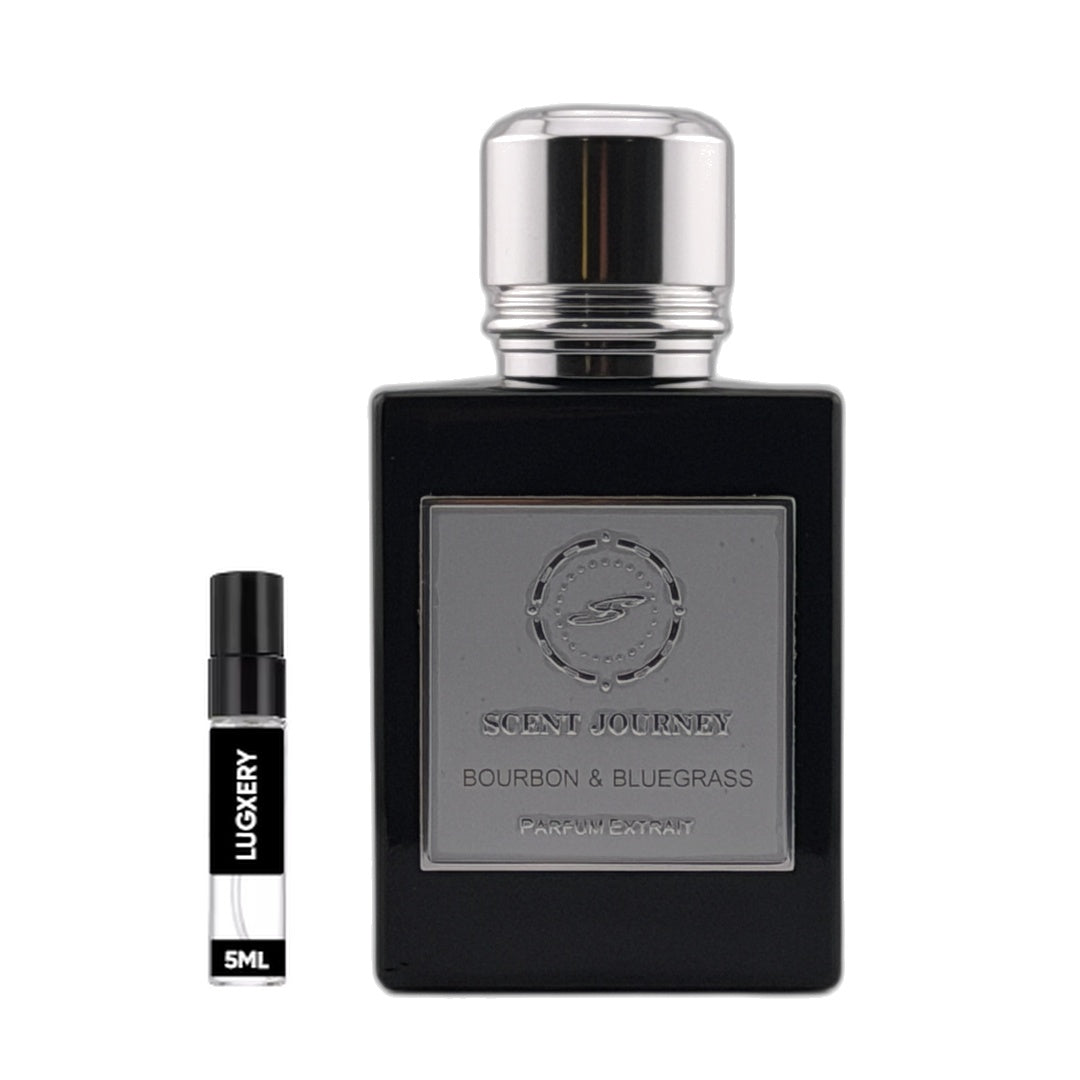 A black rectangular perfume bottle with a silver cap and a silver front label reading 'SCENT JOURNEY BOURBON & BLUEGRASS' is shown beside a small black-and-white sample spray vial labeled 'LUGERY 5ML' on a plain white background.