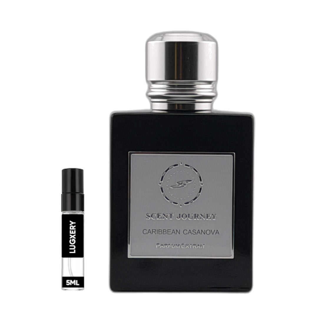 A black rectangular perfume bottle with a silver cap and a silver front label reading 'SCENT JOURNEY CARIBBEAN CASANOVA PARFUM EXTRACT' is shown beside a small travel spray vial labeled 'LUGIERY' and '5ML' on a plain white background.
