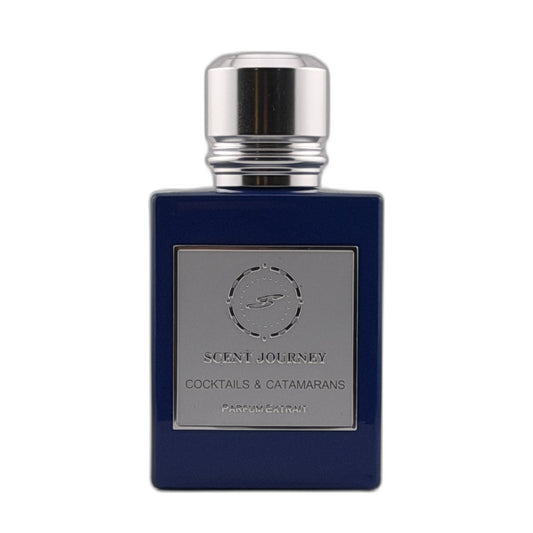 A dark blue rectangular perfume bottle with a silver metallic cap and a silver label reading 'SCENT JOURNEY COCKTAILS & CATAMARANS'.